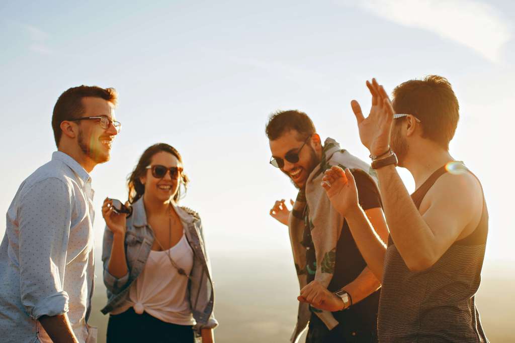 A happy group of friends smiling together outdoors.