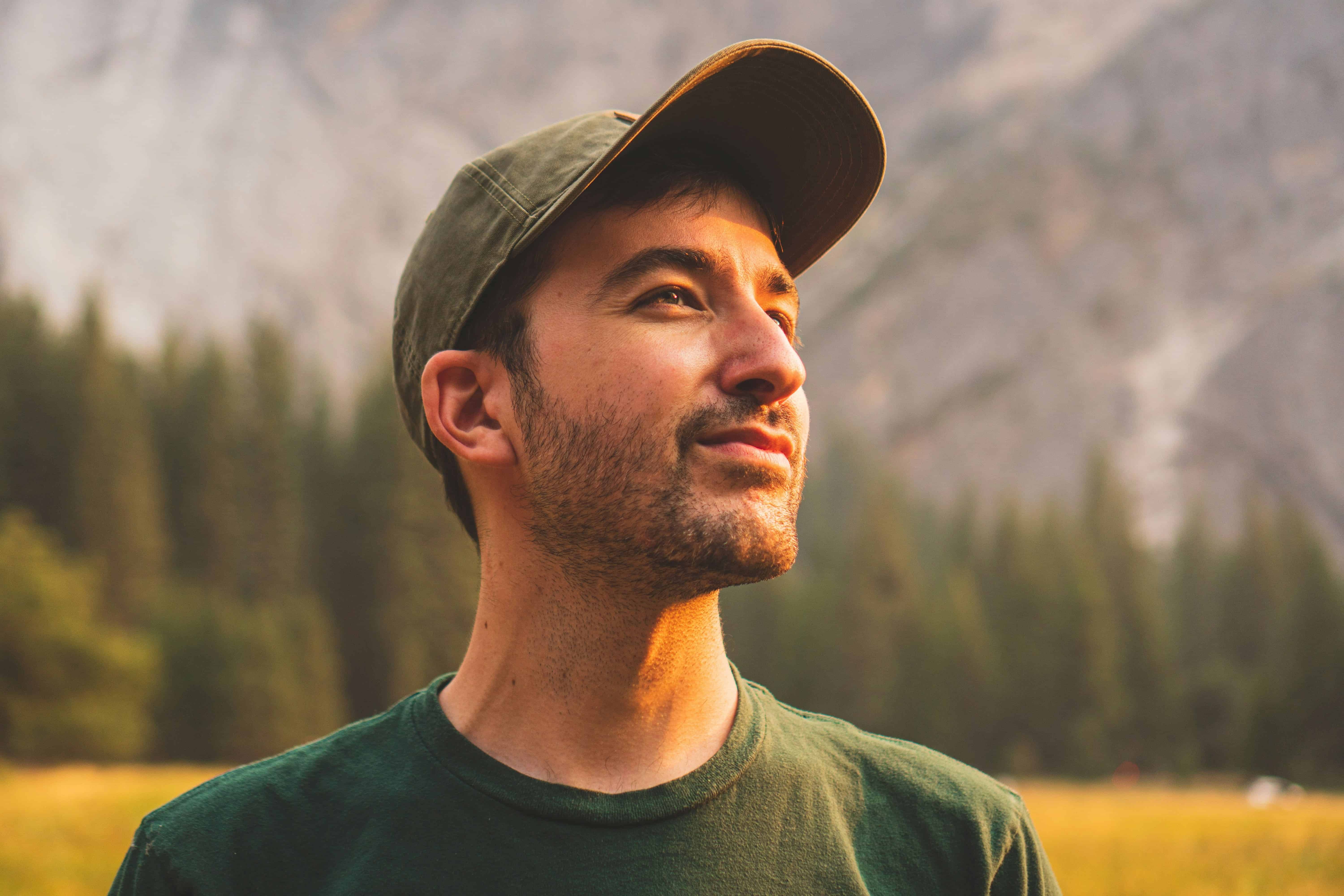 Clear-skinned man enjoying outdoor mountain scenery in nature.