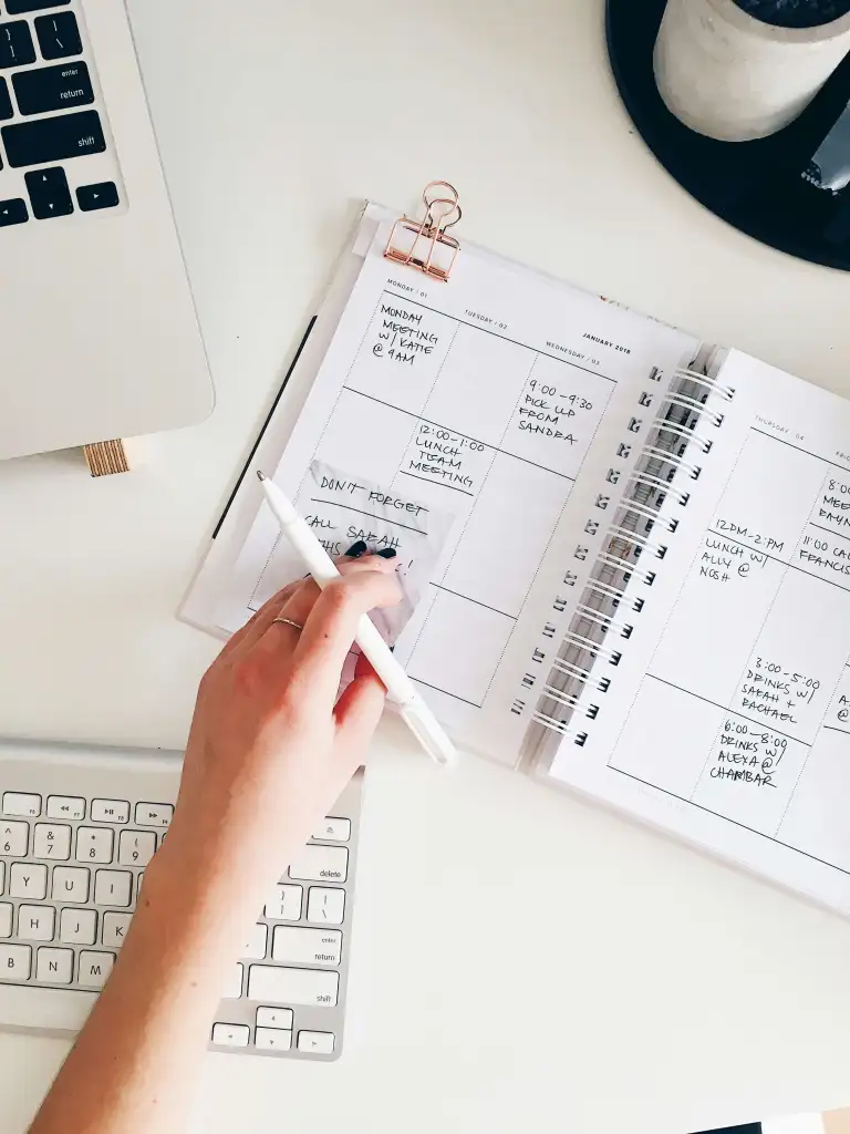 An open notebook with a handwritten schedule