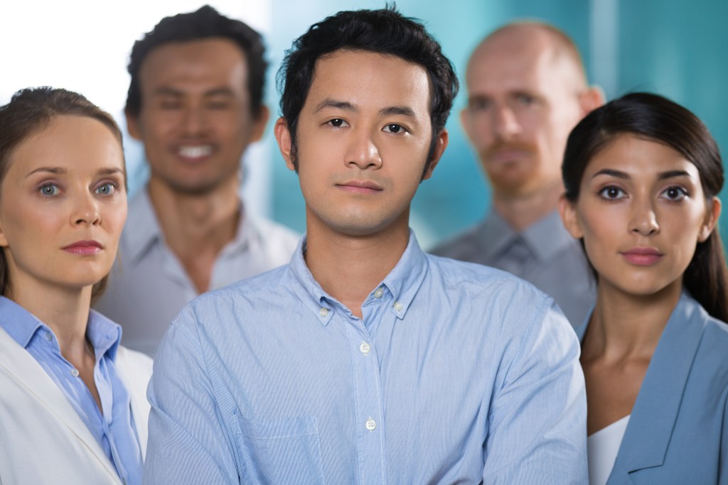 confident asian man working with strong team