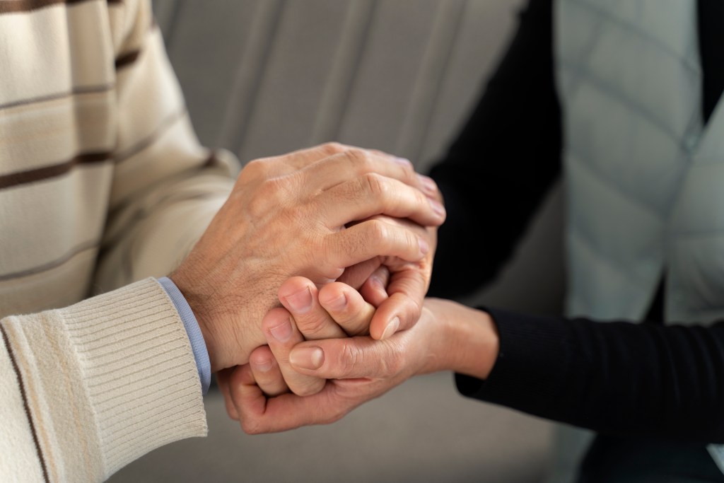close up people holding hands
